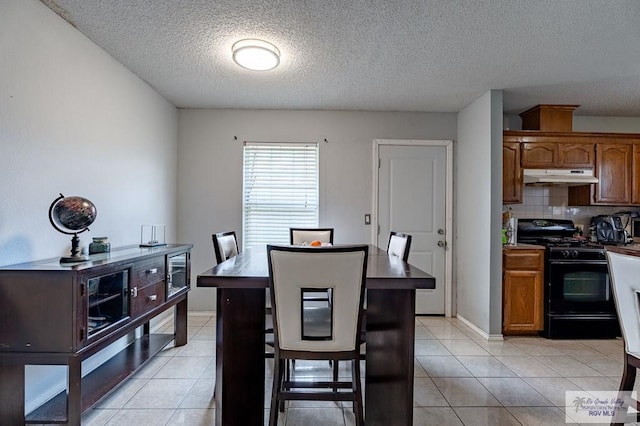 3053 Fairfield Dr, Brownsville, TX 78526 - dining room with a textured ceiling and light tile patterned floors