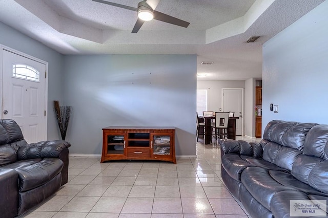 3053 Fairfield Dr, Brownsville, TX 78526 - living area with a raised ceiling, ceiling fan, light tile patterned floors, and a textured ceiling
