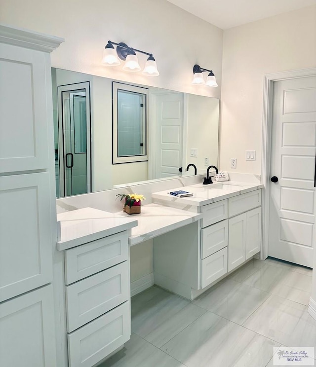 full bath with double vanity, an enclosed shower, and a sink