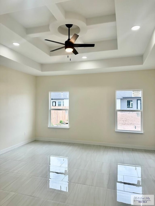 spare room with a ceiling fan, baseboards, a tray ceiling, and recessed lighting