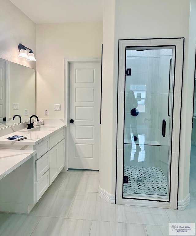 bathroom with a stall shower and vanity