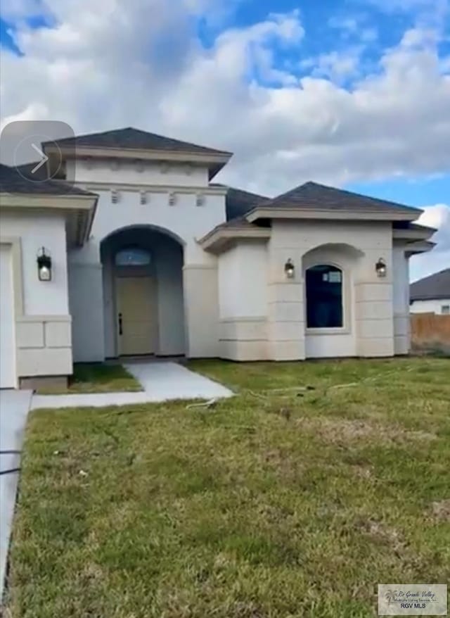 back of house featuring a lawn