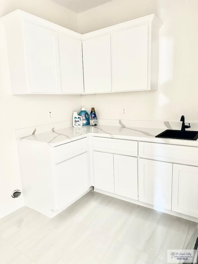 clothes washing area featuring a sink