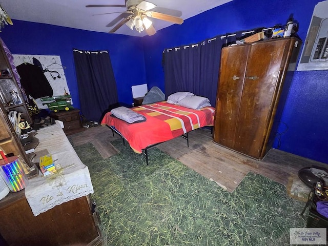 bedroom with ceiling fan and hardwood / wood-style floors