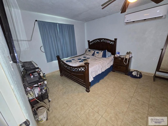 bedroom featuring a wall unit AC and ceiling fan