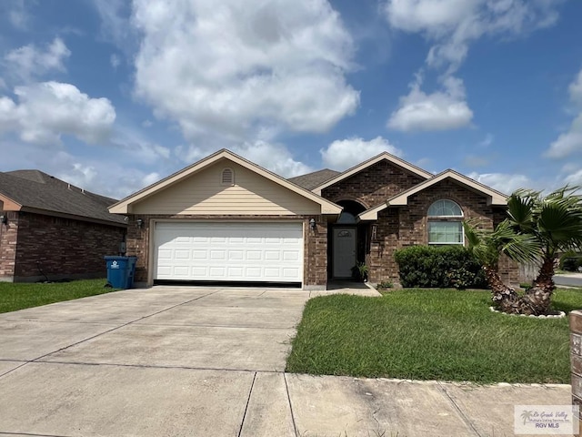 ranch-style home featuring a garage, concrete driveway, a front yard, and brick siding