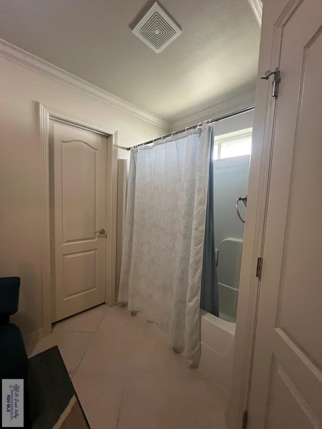 full bathroom featuring tile patterned floors, ornamental molding, and visible vents