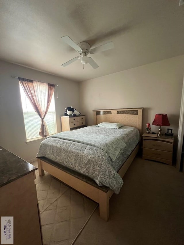 bedroom with ceiling fan and light colored carpet