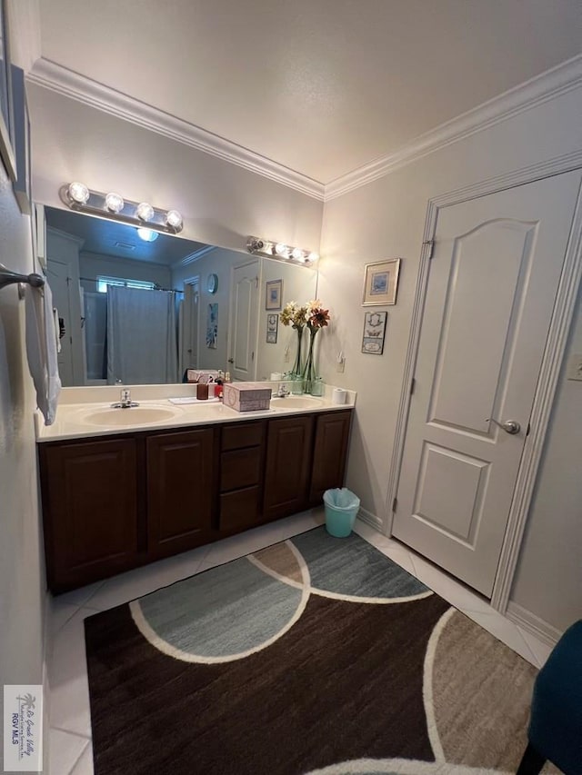 full bathroom featuring crown molding, a sink, baseboards, and double vanity