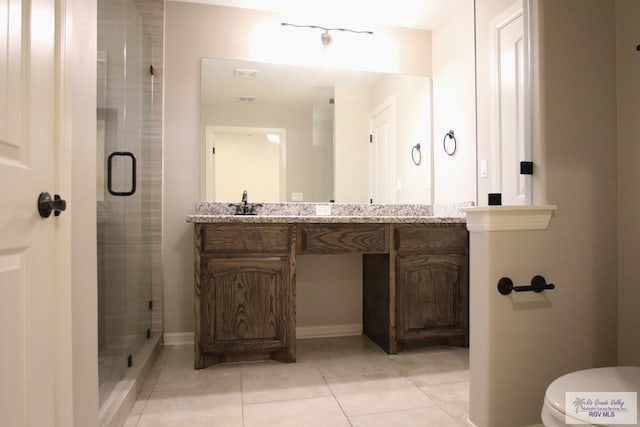 bathroom featuring toilet, tile patterned flooring, a shower stall, and vanity