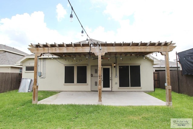 rear view of house with a patio area, a fenced backyard, a lawn, and a pergola