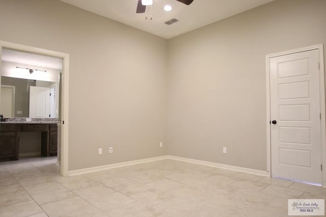 spare room with visible vents, ceiling fan, baseboards, and light tile patterned floors