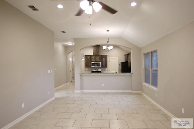 unfurnished living room featuring arched walkways, visible vents, vaulted ceiling, baseboards, and ceiling fan with notable chandelier