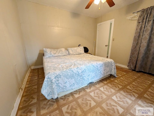 bedroom featuring ceiling fan and baseboards