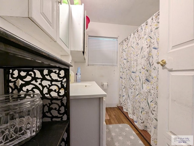 full bath featuring wood finished floors and vanity