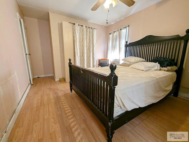 bedroom featuring baseboards, ceiling fan, and light wood-style floors