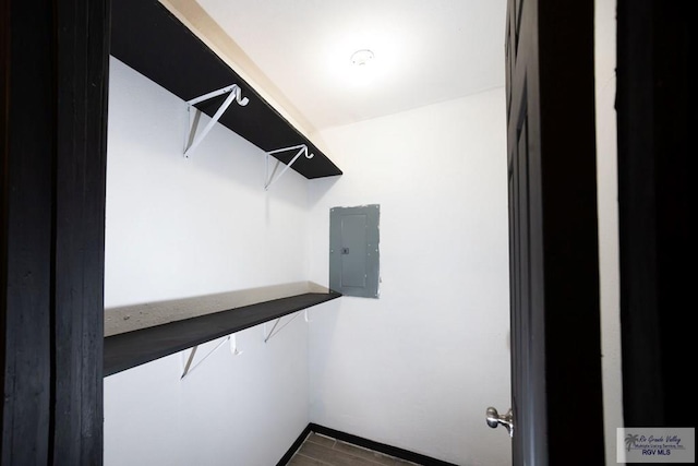 walk in closet featuring wood finished floors and electric panel