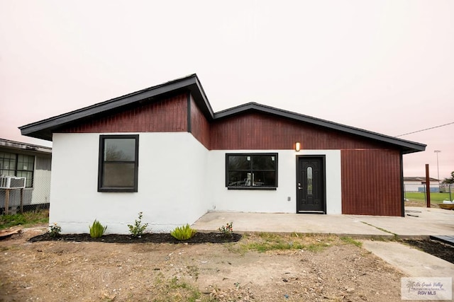 rear view of property with cooling unit, a patio area, and fence