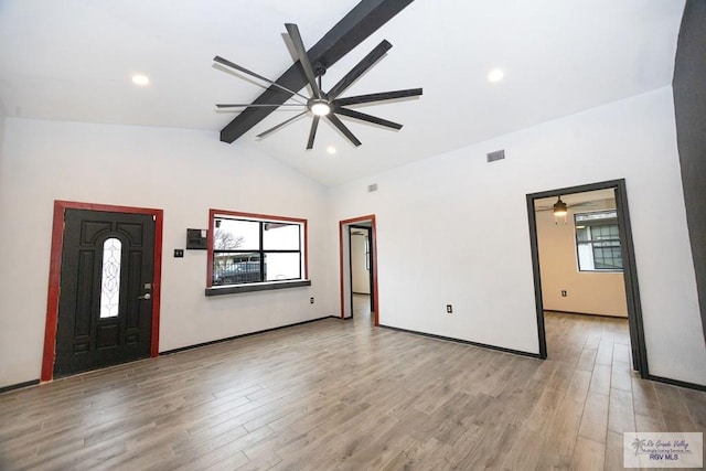 foyer with lofted ceiling with beams, ceiling fan, light wood-style flooring, and visible vents