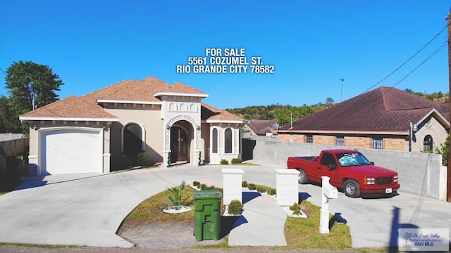 mediterranean / spanish-style house with a garage