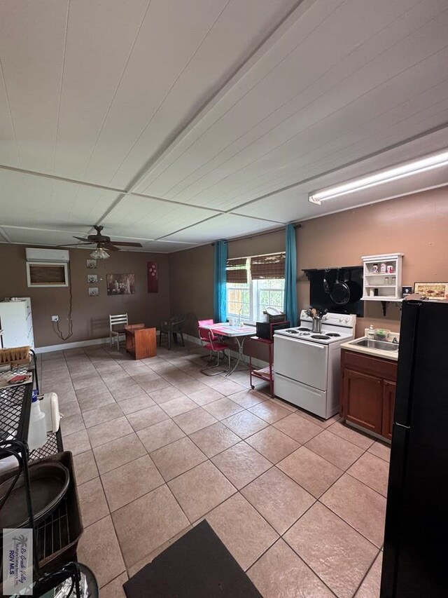 2326 Rio Hondo Rd, Harlingen, TX 78550 - kitchen featuring white electric stove, freestanding refrigerator, light tile patterned floors, and a ceiling fan