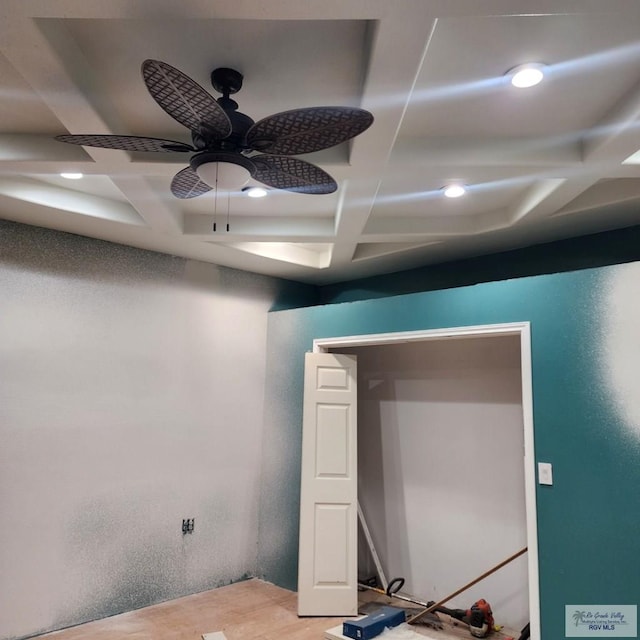 unfurnished room featuring beamed ceiling, ceiling fan, and coffered ceiling