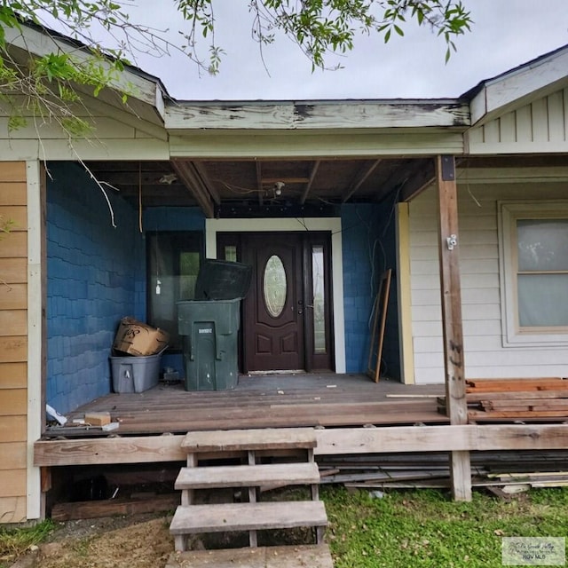 view of exterior entry featuring a wooden deck