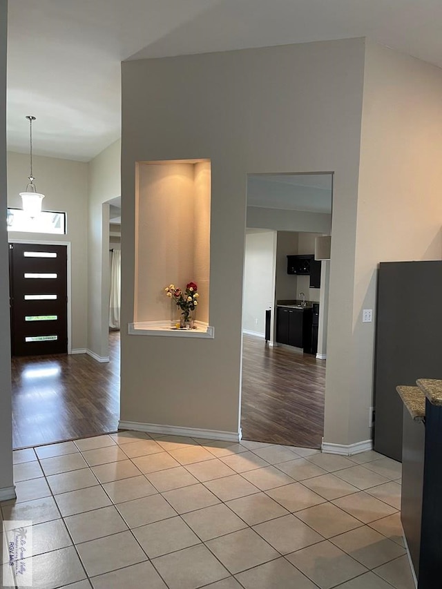 entryway with light hardwood / wood-style floors and sink