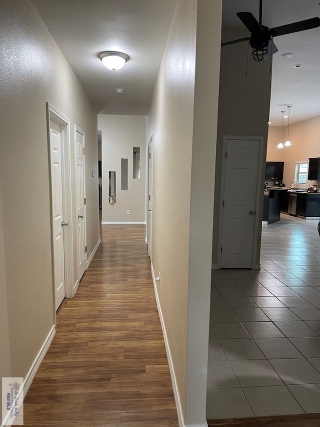 hall with dark tile patterned flooring