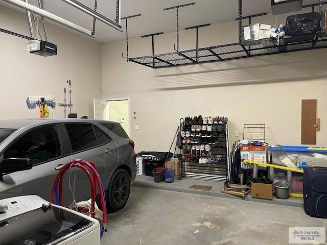 garage featuring washer / dryer and a garage door opener