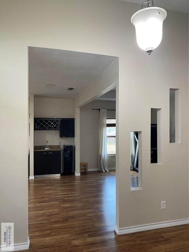 hall with dark hardwood / wood-style flooring and sink