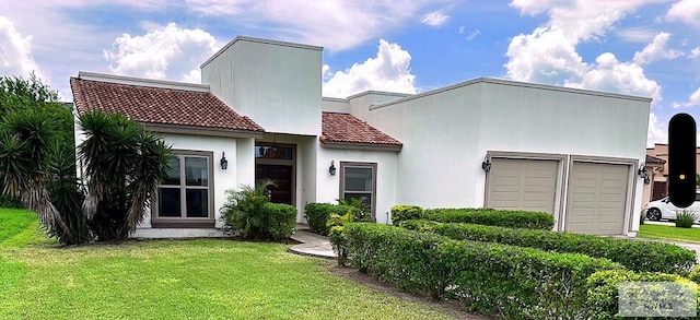 view of front of home with a garage and a front yard