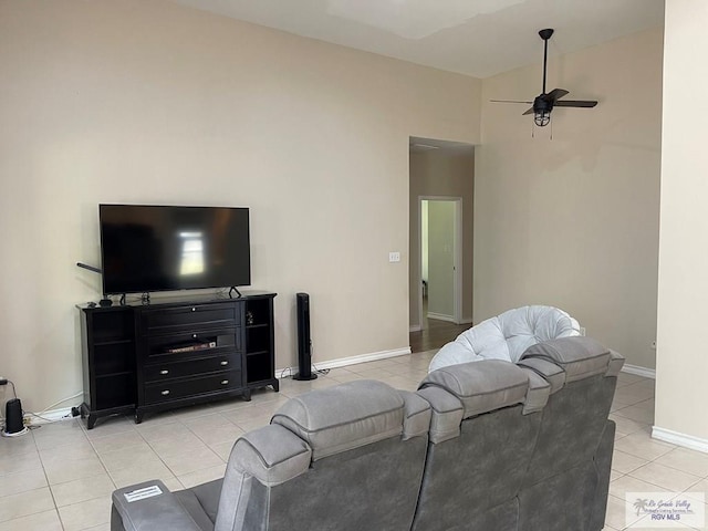 living room with light tile patterned floors, high vaulted ceiling, and ceiling fan