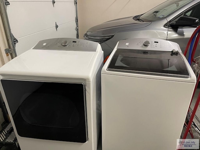 clothes washing area featuring separate washer and dryer