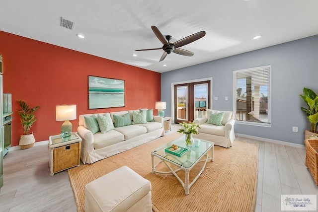 living room with french doors, ceiling fan, and light hardwood / wood-style floors