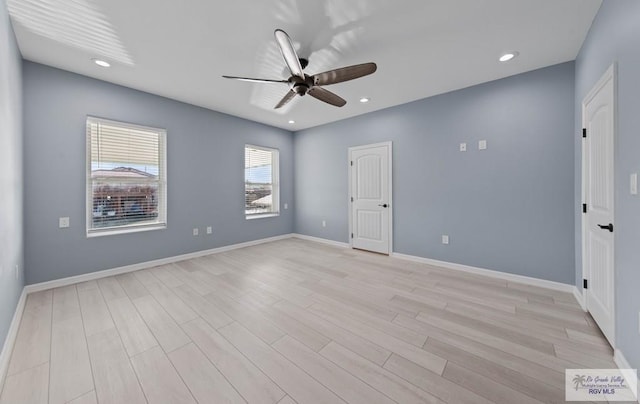 unfurnished room featuring ceiling fan and light wood-type flooring