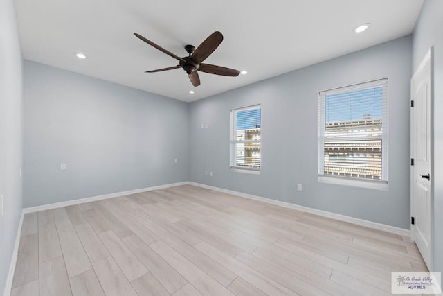 spare room featuring light hardwood / wood-style flooring and ceiling fan