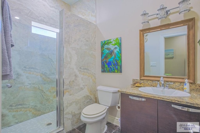 bathroom featuring vanity, toilet, an enclosed shower, and tile walls