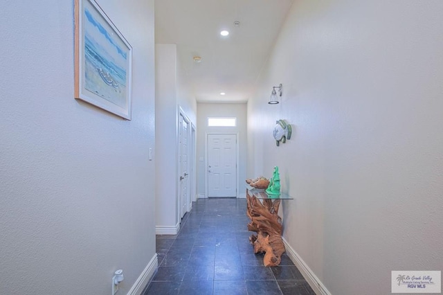 doorway to outside featuring dark tile patterned flooring