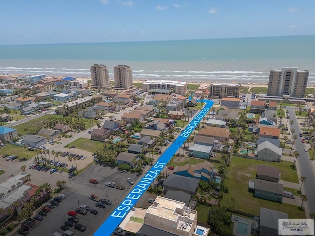 aerial view with a water view and a beach view