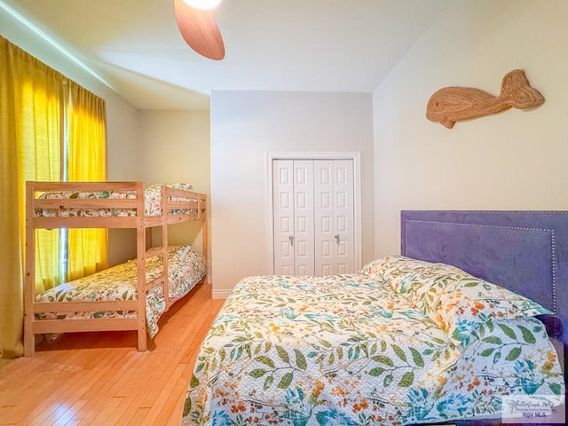 bedroom featuring hardwood / wood-style floors, a closet, and ceiling fan