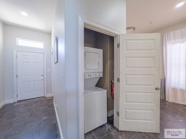 laundry area with stacked washing maching and dryer