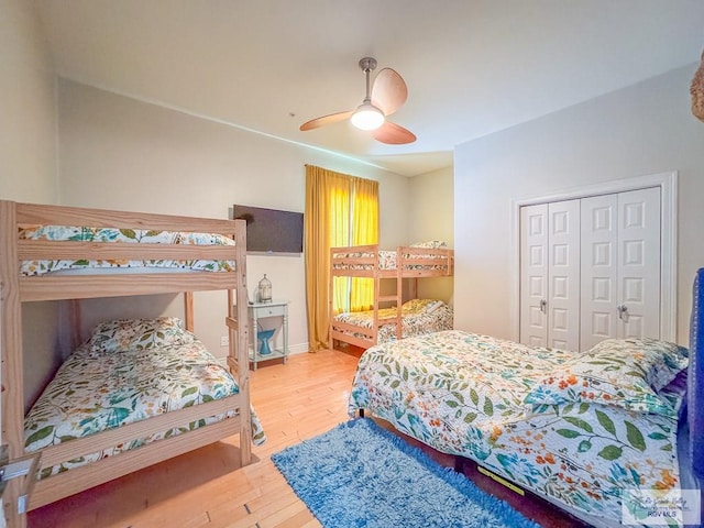 bedroom featuring hardwood / wood-style floors, a closet, and ceiling fan