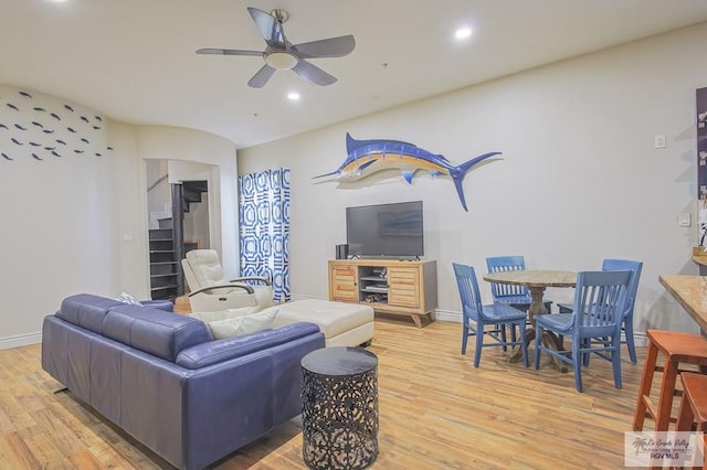 living room with light wood-type flooring and ceiling fan