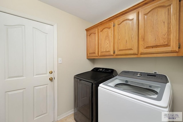 laundry room with cabinets and washer and dryer