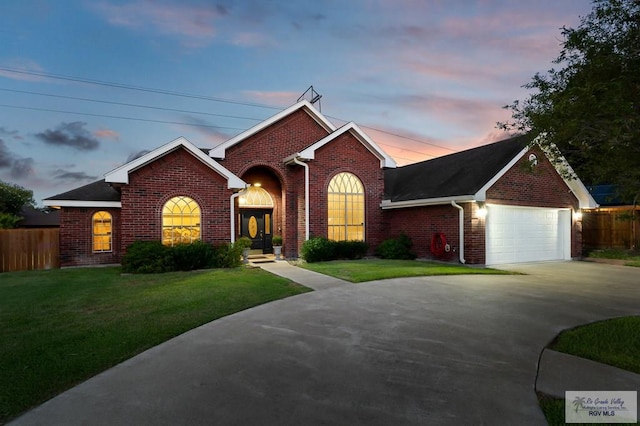 view of front of property featuring a yard and a garage