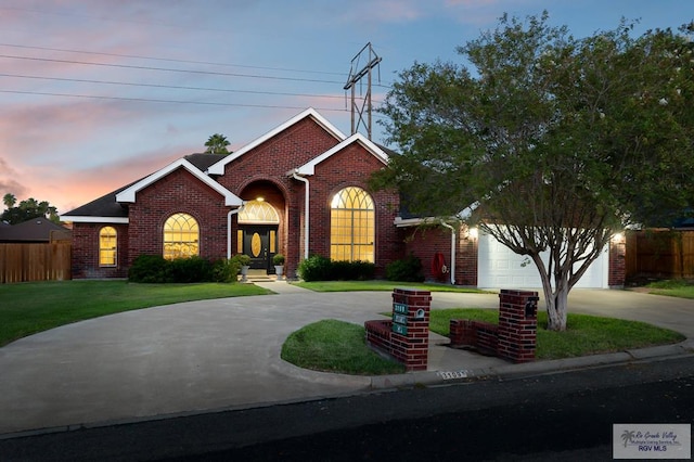 view of front of house with a yard and a garage