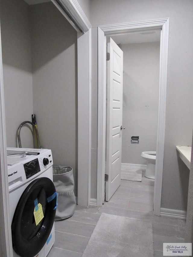 225 Country Club Rd Unit 225, Brownsville, TX 78520 - washroom featuring baseboards, washer / clothes dryer, and wood finish floors