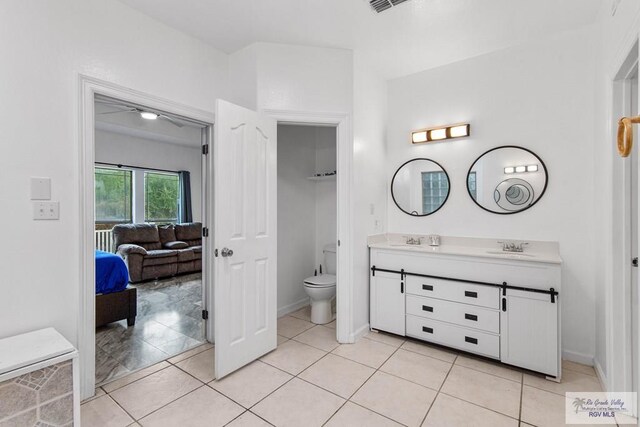 bathroom featuring tile patterned flooring, vanity, and toilet