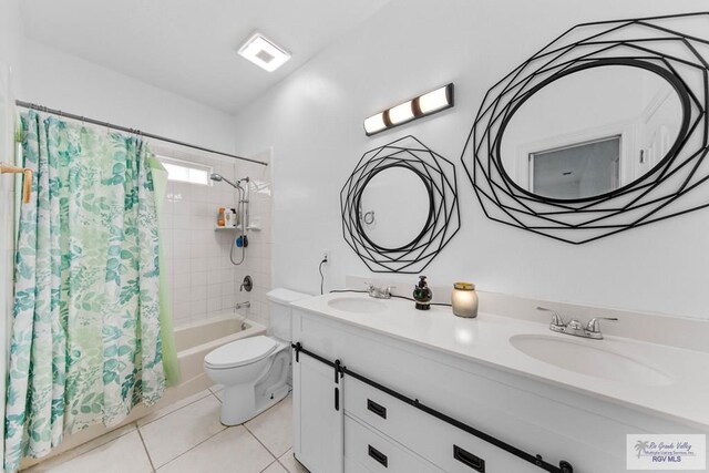 full bathroom featuring tile patterned floors, vanity, shower / bath combination with curtain, and toilet